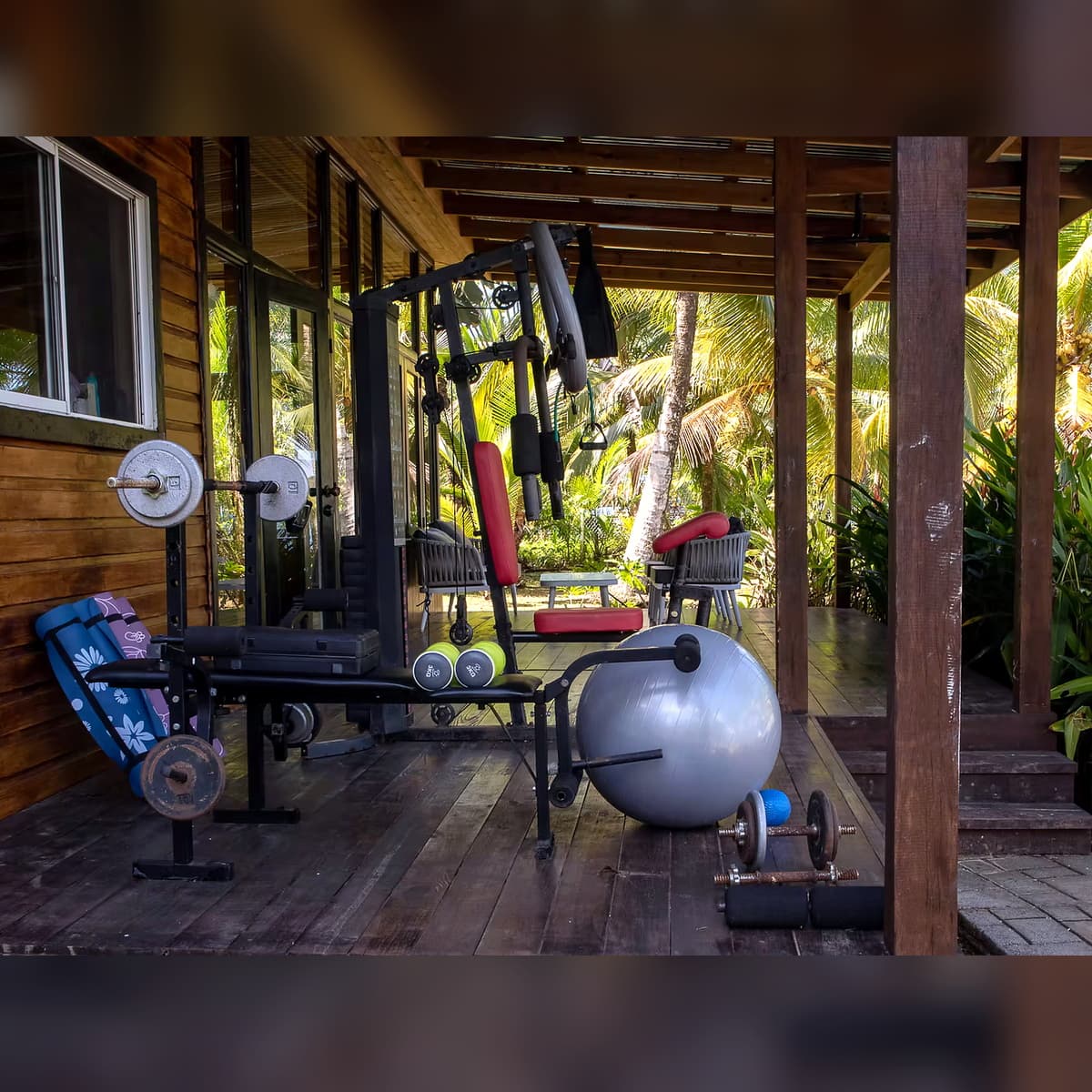 Salon Azul outdoor workout area and gym at Dolphin Blue Paradise, Bocas del Toro - patio with weights, dumbbells, fitness ball, and yoga mats